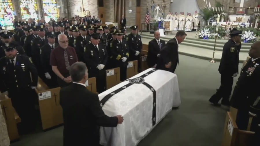 Officer Jacob Derbin’s casket arrives at St. Columbkille Church