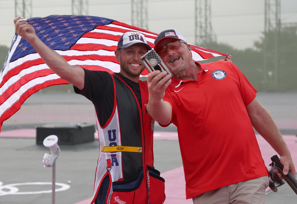 <p>Team USA's gold medalist Vincent Hancock takes a selfie with his coach following his Skeet Men's Finals win at the Asaka Shooting Range on July 26.</p>