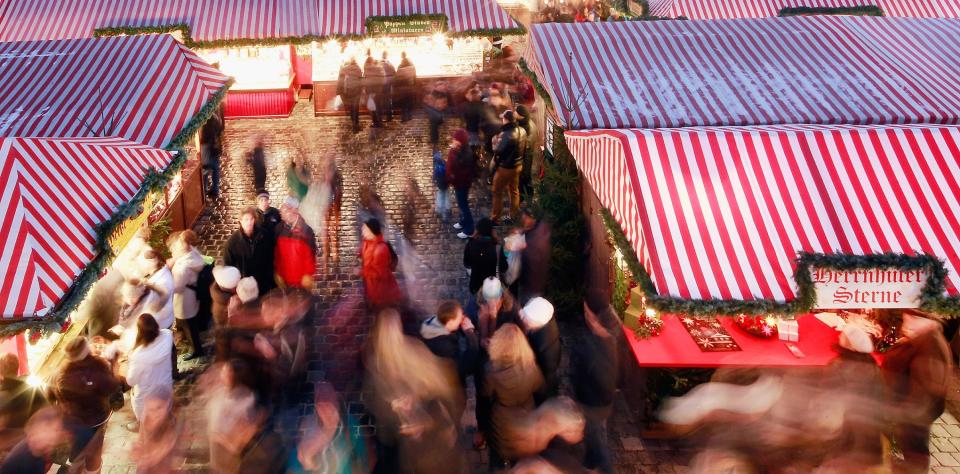 NUREMBERG, GERMANY - NOVEMBER 30: Visitors attend the traditional Christmas market 'Nuernberger Christkindlesmarkt' ahead of the opening ceremony on November 30, 2012 in Nuremberg, Germany. Originating in the 16th century the Nuremberg Christmas market is seen as one of the oldest of its kind in Germany. (Photo by Johannes Simon/Getty Images)