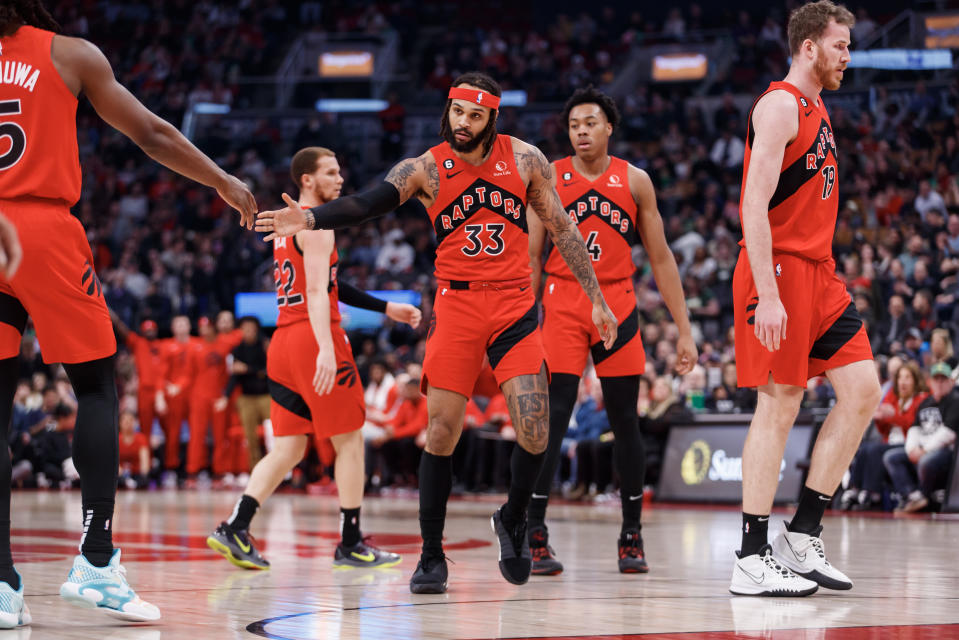 TORONTO, ON - APRIL 09: Gary Trent Jr. #33 of the Toronto Raptors high fives Precious Achiuwa #5 as he heads to the foul line in the first half of their NBA game against the Milwaukee Bucks at Scotiabank Arena on April 9, 2023 in Toronto, Canada. NOTE TO USER: User expressly acknowledges and agrees that, by downloading and or using this photograph, User is consenting to the terms and conditions of the Getty Images License Agreement. (Photo by Cole Burston/Getty Images)