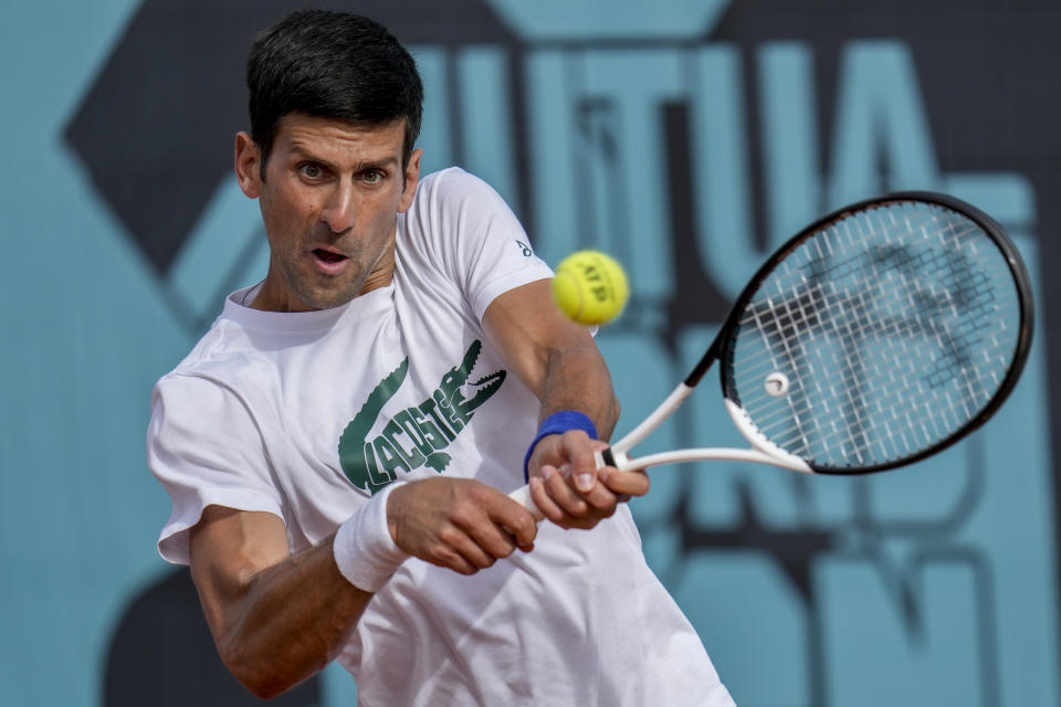 Novak Djokovic of Serbia returns the ball during a training session at the Mutua Madrid Open tennis tournament in Madrid, Spain, Saturday, April 30, 2022. (AP Photo/Manu Fernandez)