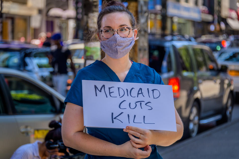 BROOKLYN, NEW YORK, UNITED STATES - 2020/07/09: Participant holding a Medicaid Cuts Kill sign at the rally. Family members, activists and concerned citizens gathered outside Woodhull Hospital holding a rally to demand justice for Sha-Asia Washington, a 26-year-old Black New Yorker, who died on July 3 during childbirth at a the Brooklyn hospital. (Photo by Erik McGregor/LightRocket via Getty Images)