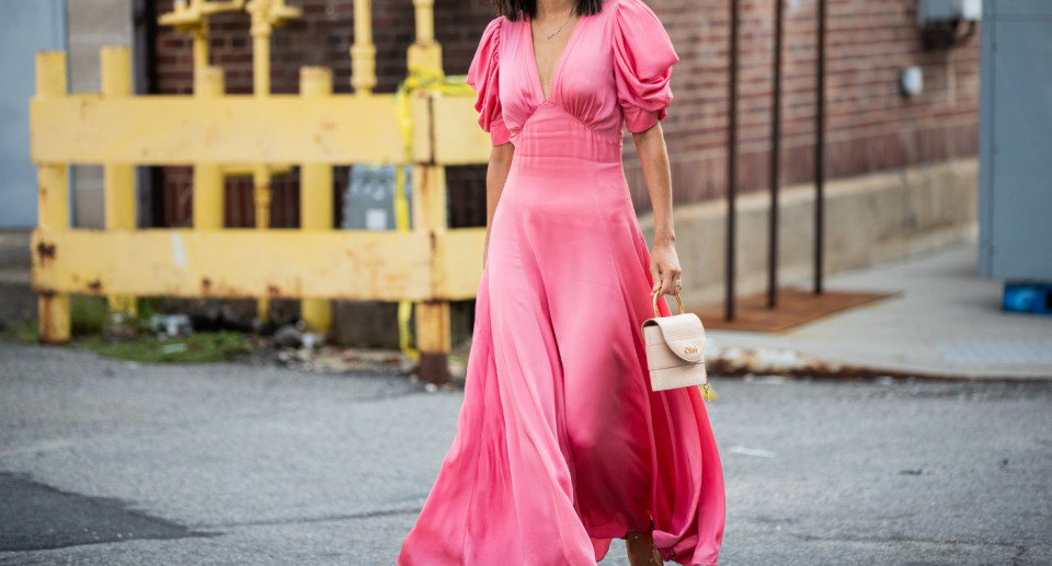 street style influencer walking down street in pink maxi dress with puffy sleeves