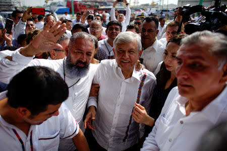 Mexico's new President Andres Manuel Lopez Obrador is surrounded by supporters as he arrives for an event to unveil his plan for oil refining, in Paraiso, Tabasco state, Mexico, December 9, 2018. Picture taken December 9, 2018. REUTERS/Alexandre Meneghini