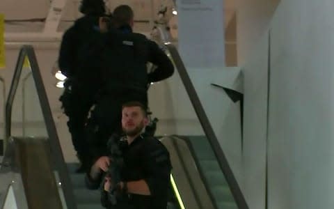 Armed police patrol a department store, near to Oxford Street