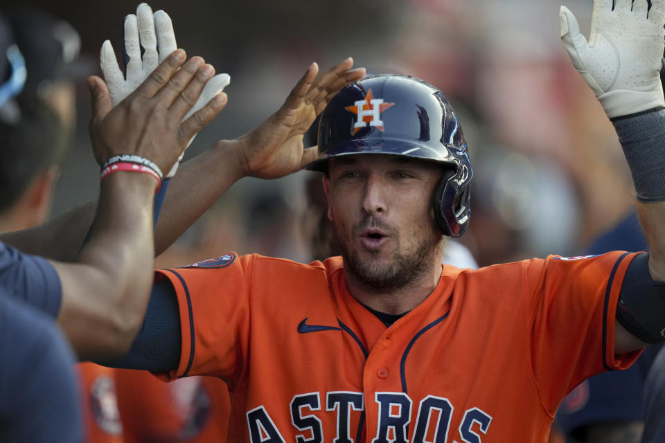 Houston Astros third baseman Alex Bregman celebrates with teammates after hitting a home run to take the lead during the ninth inning of a baseball game against the Los Angeles Angels in Anaheim, Calif., Sunday, July 16, 2023. (AP Photo/Eric Thayer)