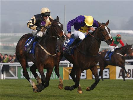 Davy Russell on Lord Windermere (R) just beats David Casey on On His Own into second place in The Gold Cup at the Cheltenham Festival horse racing meet in Gloucestershire, western England March 14, 2014. REUTERS/Eddie Keogh