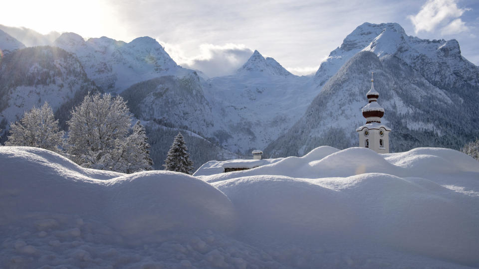 The steeple of the Loferer church is seen through the snow in Lofer, Austrian province of Salzburg on Friday, Jan. 11, 2019 after a heavy snowfall. (AP Photo/Kerstin Joensson)