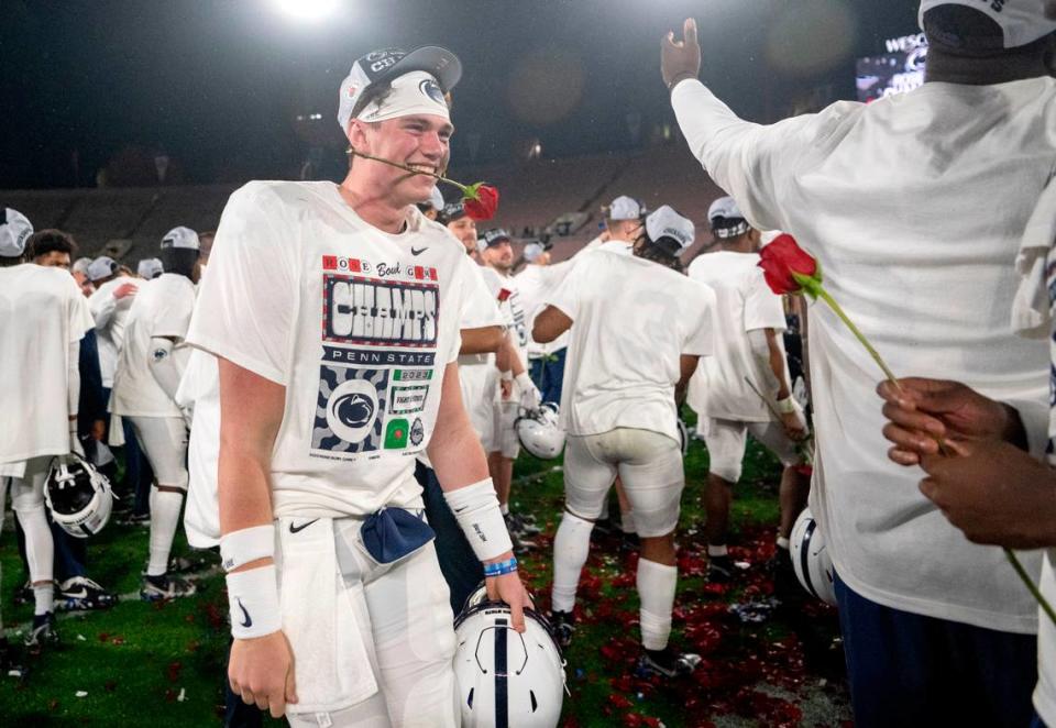 Penn State quarterback Drew Allar bites a rose as he and his teammates celebrate the 35-21 win over Utah in the Rose Bowl on Monday, Jan. 2, 2023. Abby Drey/adrey@centredaily.com