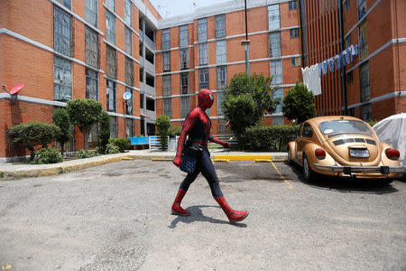 Moises Vazquez, 26, known as Spider-Moy, a computer science teaching assistant at the Faculty of Science of the National Autonomous University of Mexico (UNAM), who teaches dressed as a comic superhero Spider-Man, walks outside the building where he lives, on his way to work in Iztapalapa neighbourhood, in Mexico City, Mexico, May 27, 2016. REUTERS/Edgard Garrido