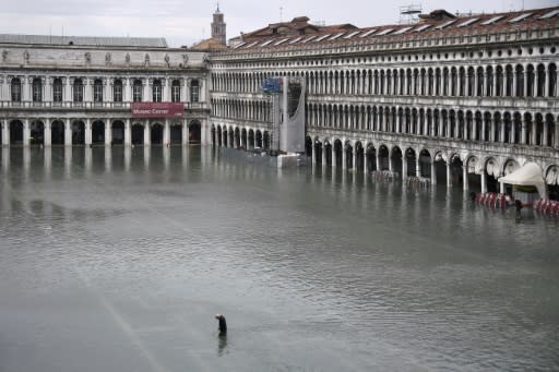 An exceptional high tide, the highest to hit the city in half a century, left St. Mark's Square flooded and forced tourists wading through the streets to seek shelter