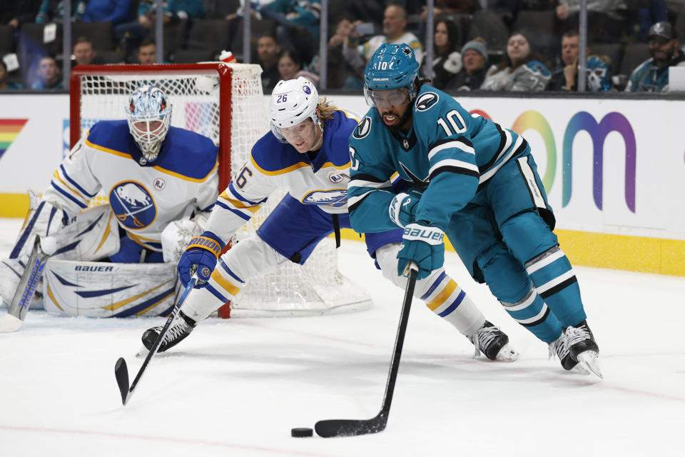 Buffalo Sabres defenseman Rasmus Dahlin (26) compete for possession of the puck against the San Jose Sharks left wing Anthony Duclair (10) during the first period of an NHL hockey game Saturday, Jan. 27, 2024, in San Jose, Calif. (AP Photo/Josie Lepe)