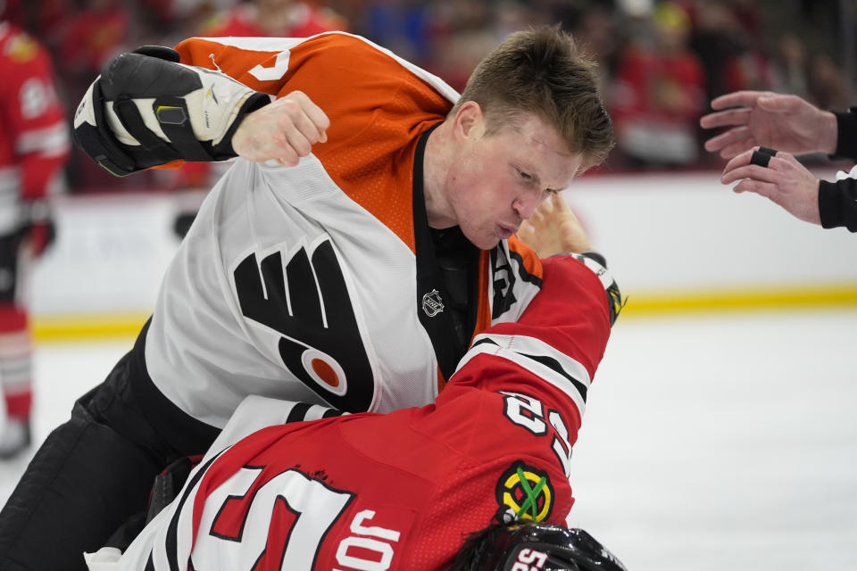 Philadelphia Flyers defenseman Nick Seeler, top, punches Chicago Blackhawks center Reese Johnson during the third period of an NHL hockey game Wednesday, Feb. 21, 2024, in Chicago. The Flyers won 3-1. (AP Photo/Erin Hooley)