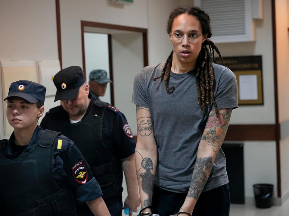 WNBA star and two-time Olympic gold medalist Brittney Griner is escorted from a courtroom after a hearing outside Moscow in August.