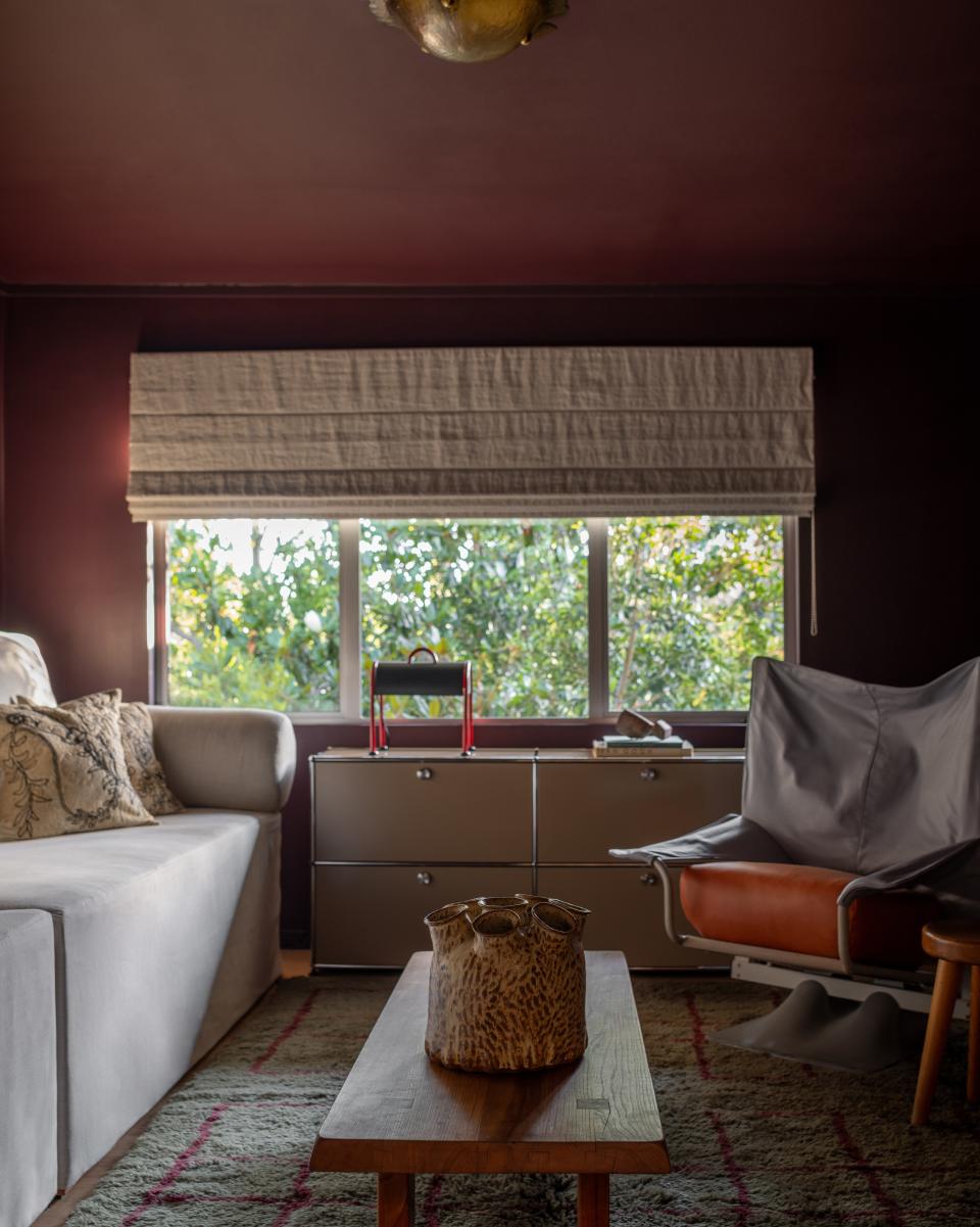 “It’s the most ideal place to wind down and watch a film,” says Zabie of the den, a warm space with walls painted in Farrow & Ball’s Brinjal. A ceramic vase by contemporary ceramicist Addison Woolsey, sourced from Lawson-Fenning, sits atop a Pierre Chapo coffee table. The seating area is characterized by a bespoke sofa bed with Studio MUKA pillows and Paolo Deganello’s Archizoom AeO chair. A Beni Rugs carpet takes center stage.