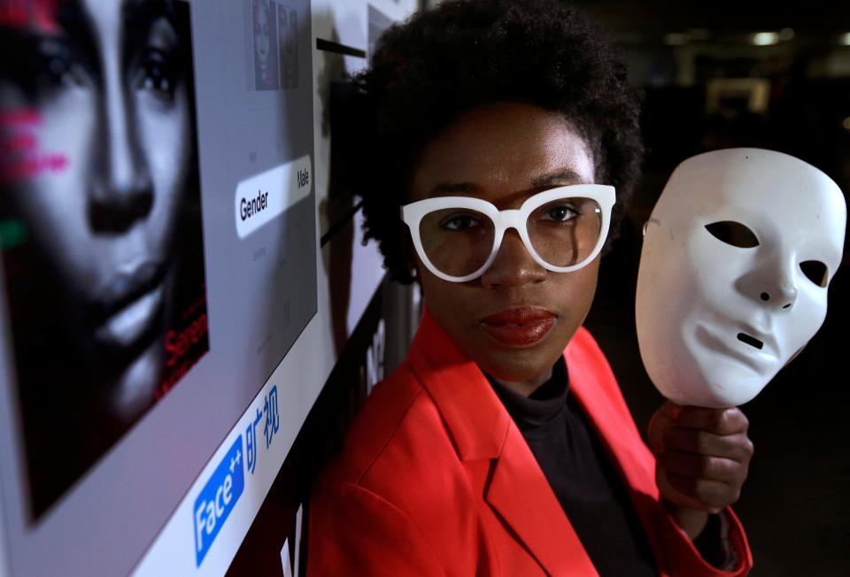 Massachusetts Institute of Technology facial recognition researcher Joy Buolamwini on Feb. 13, 2019, at the school, in Cambridge, Mass. Her research has uncovered racial and gender bias in facial analysis tools sold by companies such as Amazon that have a hard time recognizing certain faces, especially darker-skinned women. Buolamwini holds a white mask she had to use so that software could detect her face.