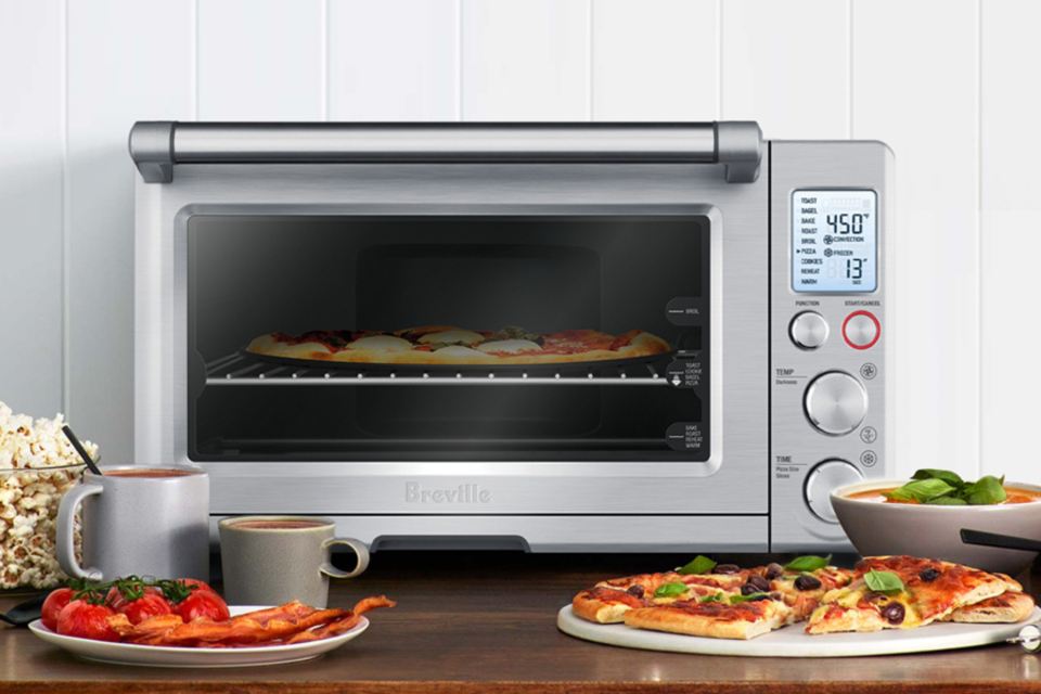 The Breville Smart Oven on a table surrounded by food