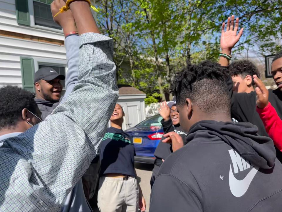 At the end of a day full of sorting, packing and delivering groceries, members of PLP Rochester have a moment of joy. On the count of three, they cheer, "PLP!"