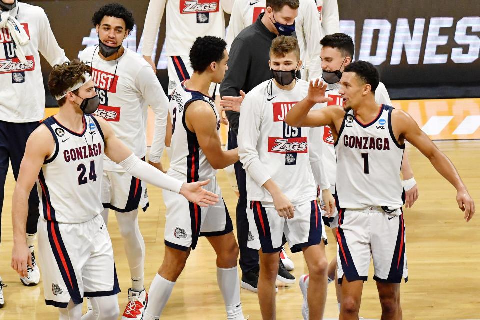 Gonzaga Bulldogs forward Corey Kispert (24) and guard Jalen Suggs (1) high five at the end of the first half in the second round of the 2021 NCAA Tournament at Hinkle Fieldhouse.