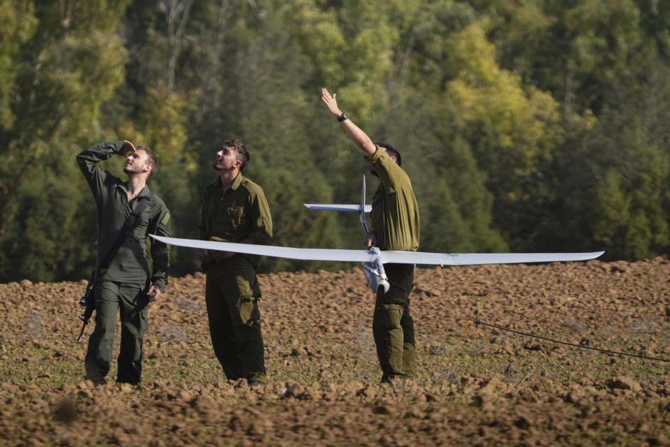 Israeli soldiers operate a drone near the Israeli-Gaza border, southern Israel, Wednesday, Dec. 6, 2023. (AP Photo/Ariel Schalit)