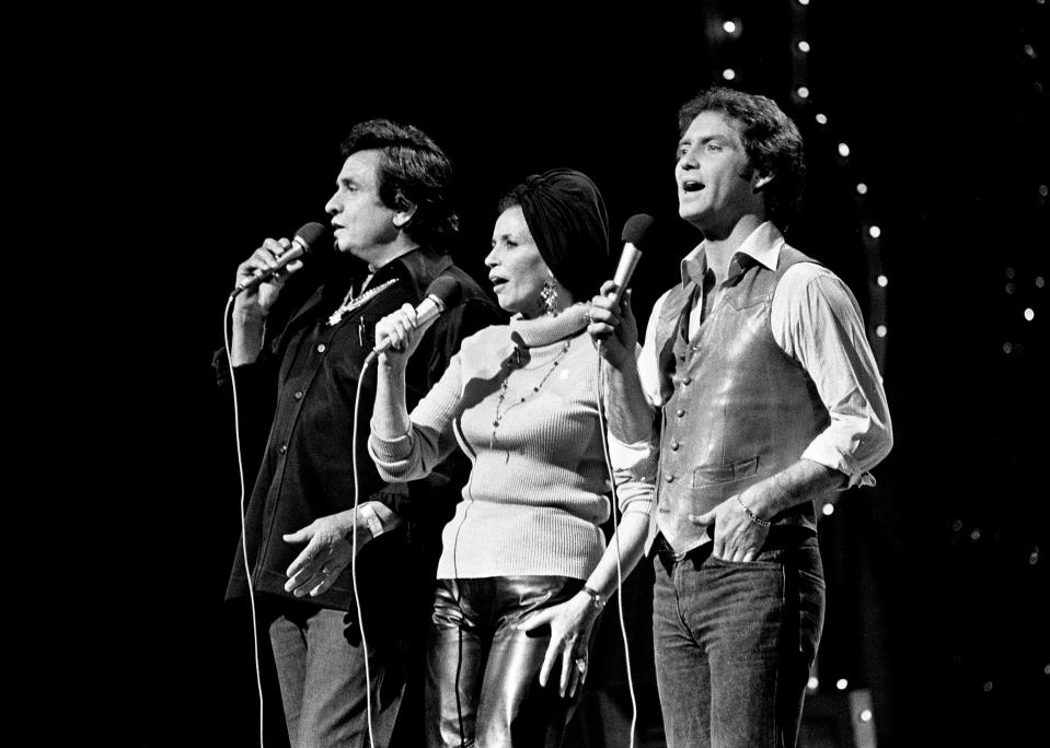 Larry Gatlin, right, teams with host Johnny Cash, left, and June Carter Cash during a rehearsal for the taping of the Johnny Cash Christmas Special at the Grand Ole Opry House Oct. 21, 1980. The show will be a one-hour special on CBS.