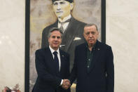 U.S. Secretary of State Antony Blinken, left, shakes hands with Turkish President Recep Tayyip Erdogan during their meeting at Esenboga airport in Ankara, Turkey, Monday, Feb. 20, 2023. (AP Photo/Burhan Ozbilici, Pool)