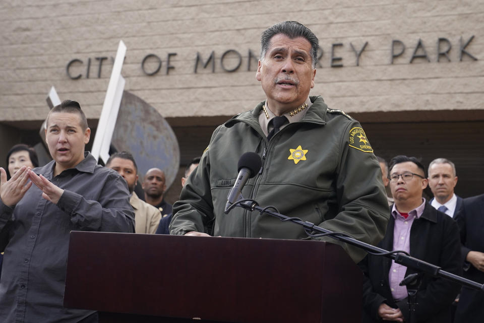 Los Angeles County Sheriff Robert Luna, at podium, briefs the media outside the Civic Center in Monterey Park, Calif., Sunday, Jan. 22, 2023. Monterey Park Mayor Henry Lo, second from right. A mass shooting at a Los Angeles-area ballroom dance club following a Lunar New Year celebration, set off a manhunt for the suspect. (AP Photo/Damian Dovarganes)