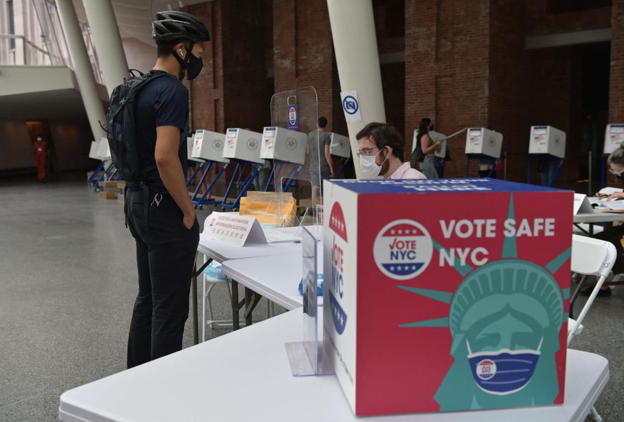 Residents vote during the New York City mayoral primary election at the Brooklyn Museum polling station on June 22, 2021, in New York City. New York City residents cast ballots in a Democratic primary on June 22, 2021, that will select the candidate almost certain to take over as mayor tasked with shaping the post-pandemic future of America's largest metropolis. Registered Democrats will choose from a diverse group of 13 candidates for the job, often called "the second-most difficult" in the United States after that of the president.