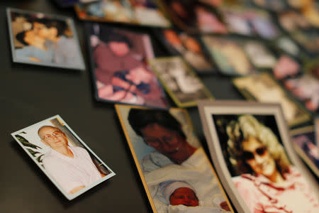 Darlene Coker is shown on a kitchen table full of many personal pictures of her family life in California, U.S. August 15, 2018. REUTERS/Mike Blake