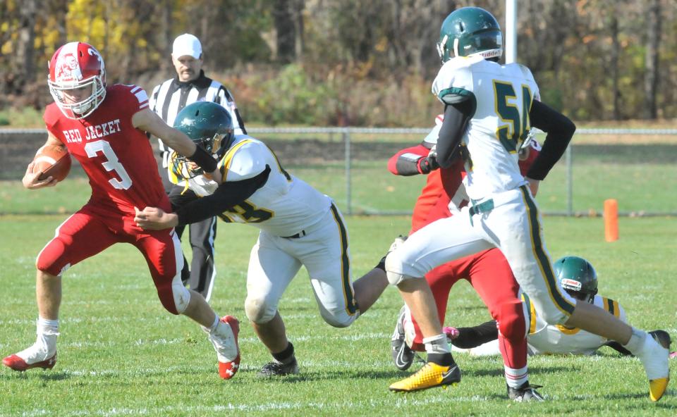 Red Jacket quarterback Micah Harshfield (3) tries to turn the corner during a game against Finney.