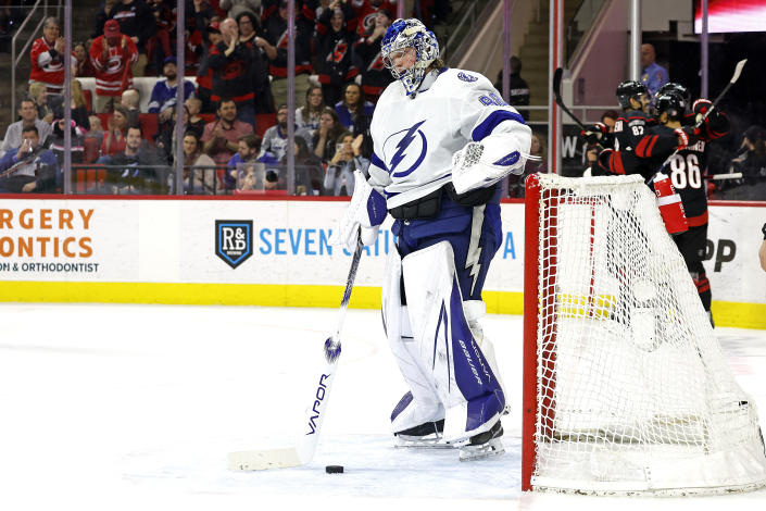 Tampa Bay Lightning goaltender Andrei Vasilevskiy (88) stands near the puck while the Carolina Hurricanes celebrate a goal by Teuvo Teravainen (86) during the second period of an NHL hockey game in Raleigh, N.C., Sunday, March 5, 2023. (AP Photo/Karl B DeBlaker)