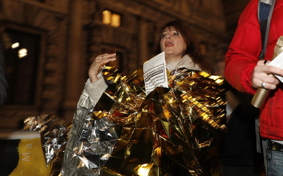 A woman protests Italian populist's government crackdown on asylum-seekers, in Milan, Italy, Monday, Jan. 7, 2019. Several governors have pledged to challenge the Italian populist’s government crackdown on asylum-seekers. Provisions of a law, approved first in the form of a government decree and later by Parliament in December, take effect Feb. 1. The new law tightens criteria for migrants receiving humanitarian protection, granting that status only to victims of labor exploitation, human trafficking, domestic violence, natural calamities and a few other limited situations, such as needing medical care. (AP Photo/Antonio Calanni)