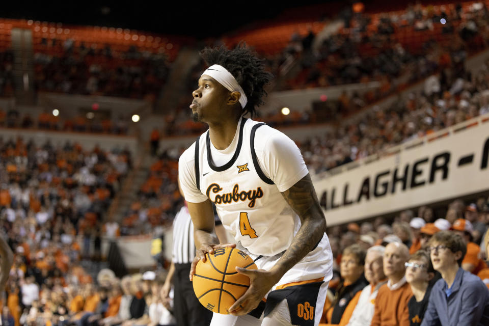 Oklahoma State's Woody Newton (4) looks to shoot in the first half of an NCAA college basketball game against Mississippi in Stillwater, Okla., Saturday, Jan. 28, 2023. (AP Photo/Mitch Alcala)