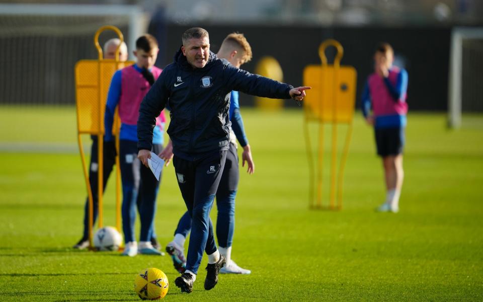 Preston manager Ryan Lowe, right, runs training - Jon Super