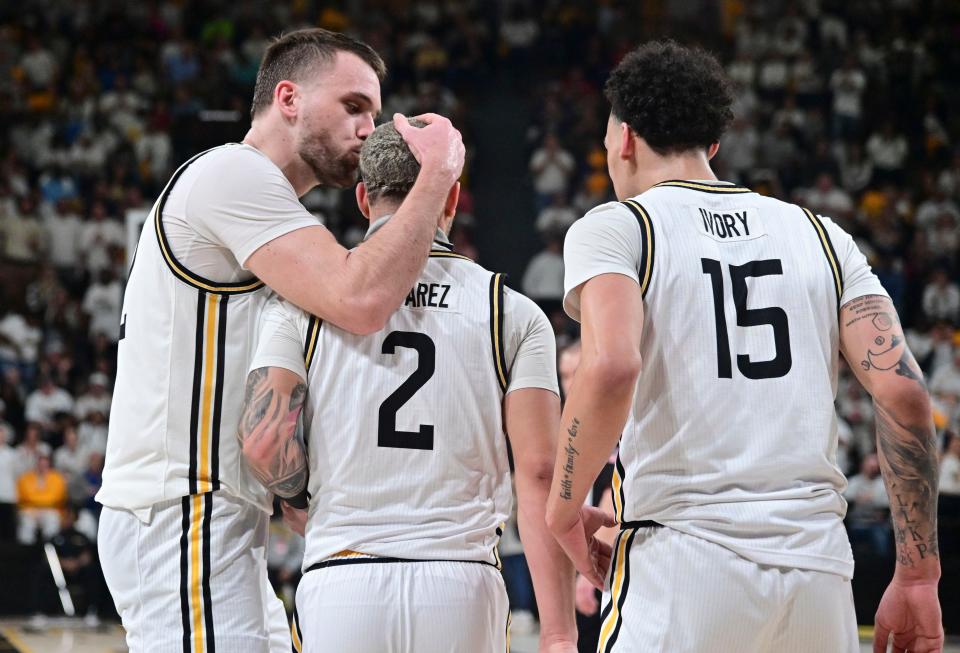 Southern Miss Golden Eagles forward Felipe Haase (22) reacts with guard Neftali Alvarez (2) and  guard Donovan Ivory (15)  during the second half of the game against the Louisiana Ragin' Cajuns at Reed Green ColiseumLouisiana Ragin' Cajun