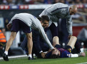 FC Barcelona's Lionel Messi receives medical attention after going down injured during the Spanish La Liga soccer match between FC Barcelona and Sevilla at the Camp Nou stadium in Barcelona, Spain, Saturday, Oct. 20, 2018. (AP Photo/Manu Fernandez)