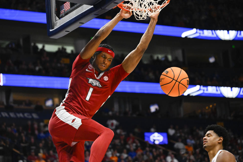 Arkansas guard Ricky Council IV (1) dunks on Auburn during the first half of an NCAA college basketball game in the second round of the Southeastern Conference tournament, Thursday, March 9, 2023, in Nashville, Tenn.(AP Photo/John Amis)