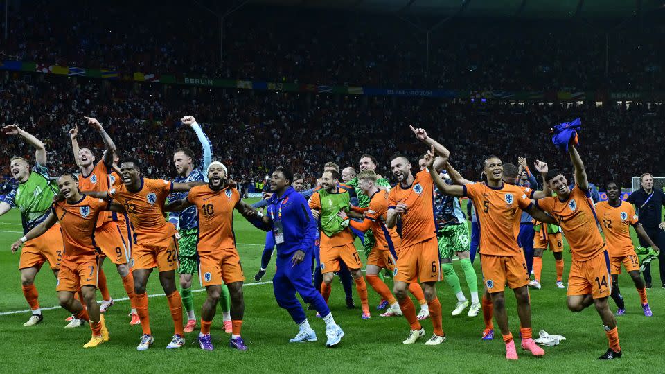 Dutch players dance to 'Links Rechts' on the pitch after beating Turkey in the quarterfinals. - John MacDougall/AFP/Getty Images