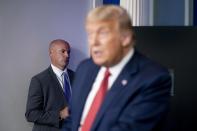 A member of the Secret Service stands guard as President Donald Trump speaks at a news conference in the James Brady Press Briefing Room at the White House, Monday, Aug. 10, 2020, in Washington. Trump briefly left because of a security incident outside the fence of the White House. (AP Photo/Andrew Harnik)