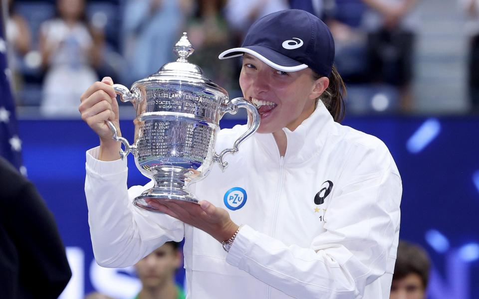 Iga Swiatek of Poland celebrates with the US Open trophy after defeating Ons Jabeur  - GETTY