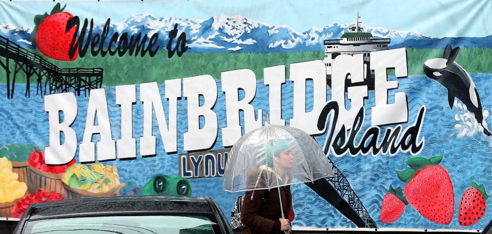 Myriah Riedel makes her way along the sidewalk of Bainbridge Island's Winslow Way on a very rainy Thursday, Jan. 23, 2020.