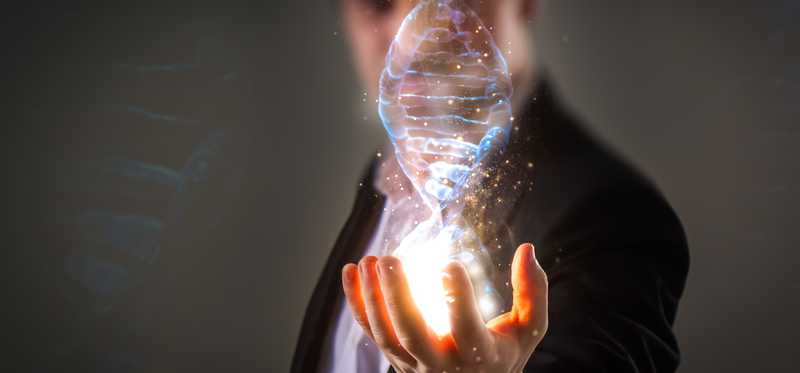 A person holds a digital-looking dna double helix in his palm.
