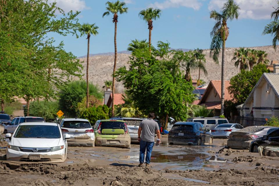 A city worker surveys the mud damage on Horizon Road in Cathedral City on August 22, 2023.