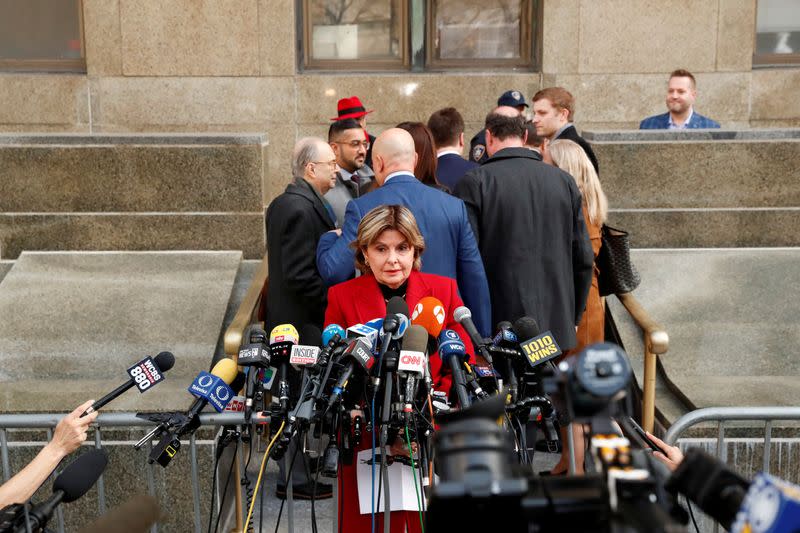 Film producer Harvey Weinstein's defense team walks away from the press conference area as Attorney Gloria Allred speaks with the media following Weinstein's guilty verdict in his sexual assault trial in New York