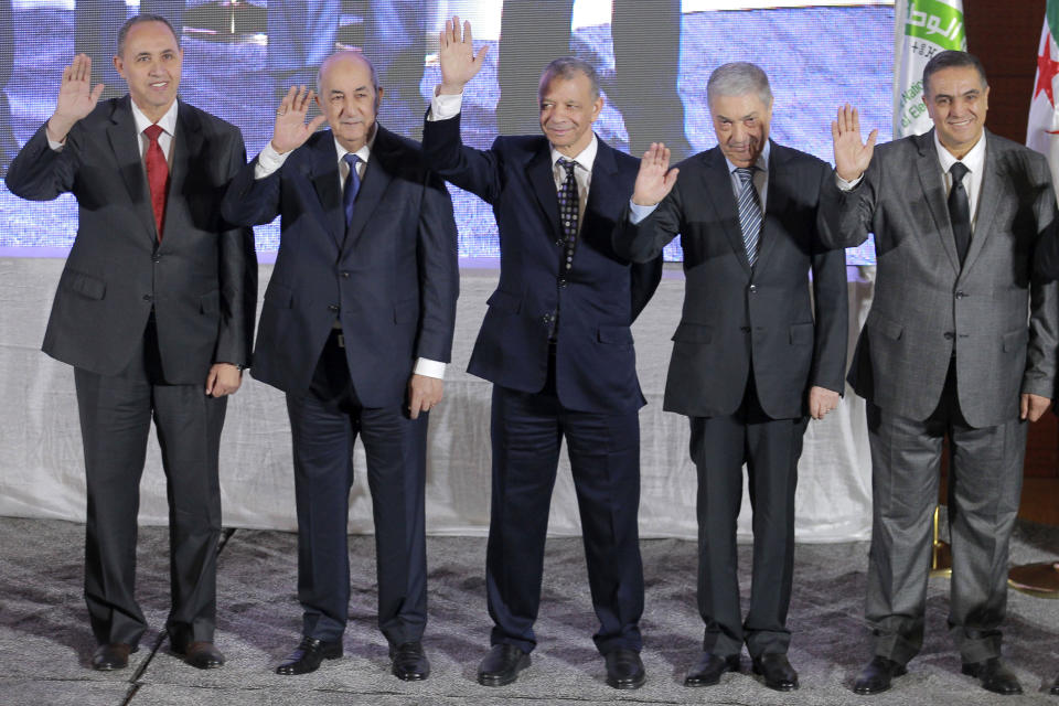 FILE - In this Oct. 17, 2019 file photo, the five candidates for the upcoming Dec. 12, presidential election, from left to right, Azzedine Mihoubi, Abdelmajid Tebboune, Abdelkader Bengrina, Ali Benflis and Abdelaziz Belaid pose prior to a media conference in Algiers. Algeria's powerful army chief promises that a presidential election on Thursday, Dec. 12, 2019 will define the contours of a new era for a nation where the highest office has stood vacant for eight months. The tenacious pro-democracy movement which forced leader Abdelaziz Bouteflika to resign after 20 years in power doesn't trust the confident claim and is boycotting the vote. (AP Photo/Fateh Guidoum, File)