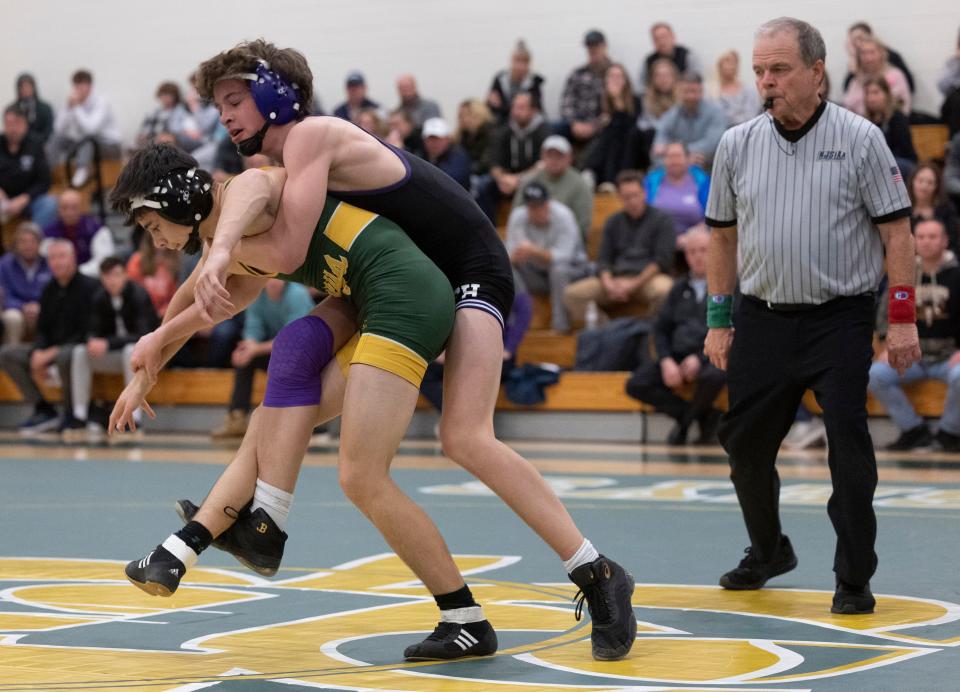 Rumson-Fair Haven's Walker Skove (132) takes Red Bank Catholic's Michael Miike to the mat in his 8-1 win Thursday night in the Bulldogs' 39-19 win over the Caseys.