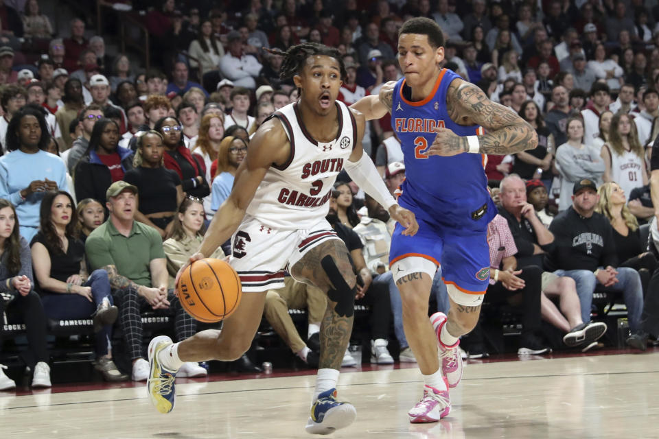South Carolina guard Meechie Johnson (5) drives to the basket past Florida guard Riley Kugel (2) during the first half of an NCAA college basketball game Saturday, March 2, 2024, in Columbia, S.C. (AP Photo/Artie Walker Jr.)