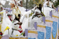 Maids in the Krewe of Zulu parade wear safety harnesses as they parade on Jackson Avenue on Mardi Gras Day in New Orleans, Tuesday, Feb. 25, 2020. (AP Photo/Rusty Costanza)