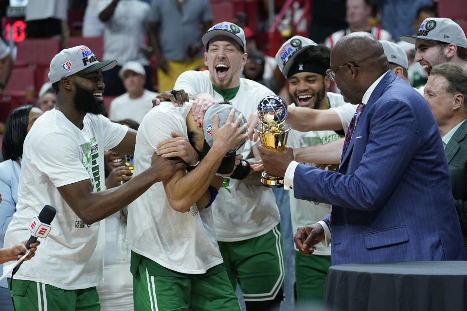 Boston Celtics forward Jayson Tatum (0) receives the NBA Eastern Conference MVP trophy after defeating the Miami Heat in Game 7 of the NBA basketball Eastern Conference finals playoff series, Sunday, May 29, 2022, in Miami. (AP Photo/Lynne Sladky)