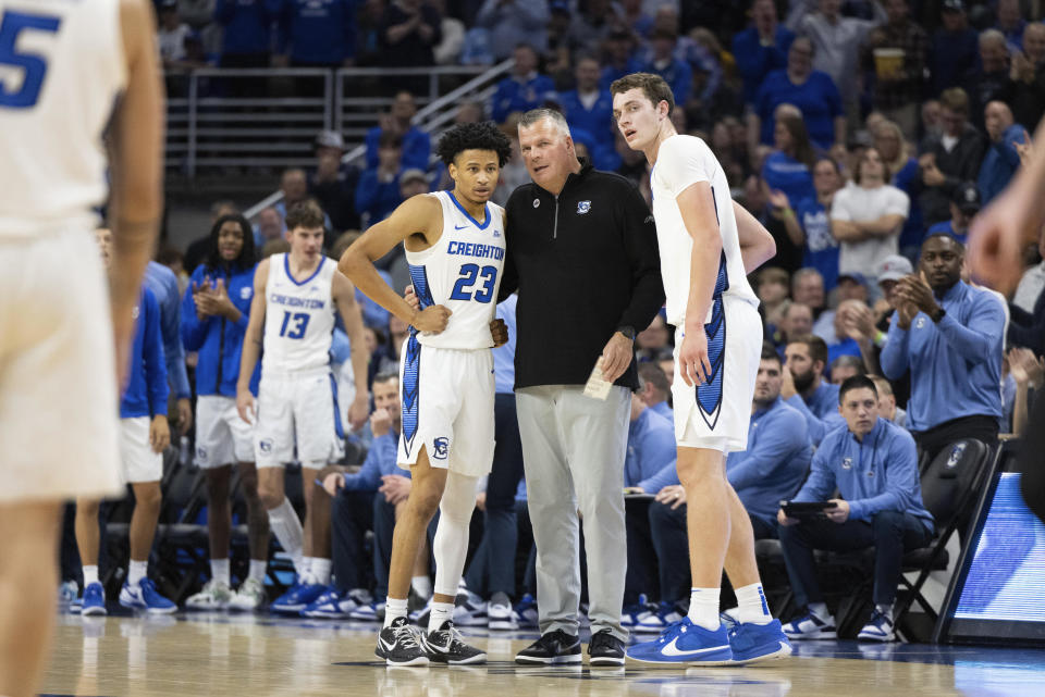 Creighton coach Greg McDermott, center, talks with Trey Alexander, left, and Ryan Kalkbrenner during a break in play against Iowa during the first half of an NCAA college basketball game Tuesday, Nov. 14, 2023, in Omaha, Neb. (AP Photo/Rebecca S. Gratz)